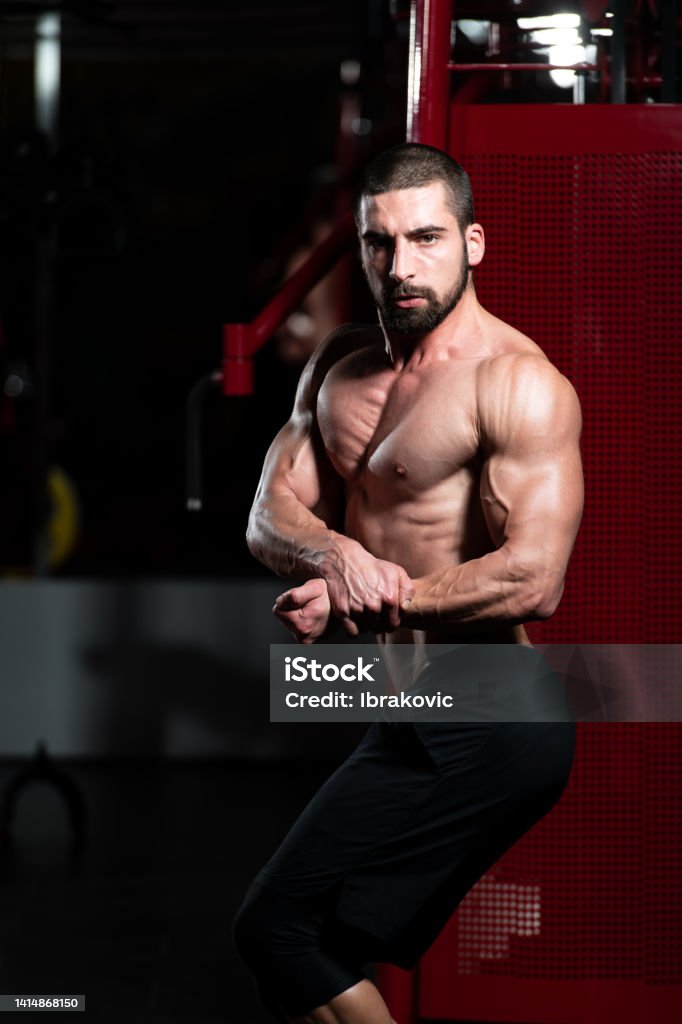 Bodybuilder Side Post Bodybuilder Performing Side Chest Pose Stock Photo - Download Image Now ...