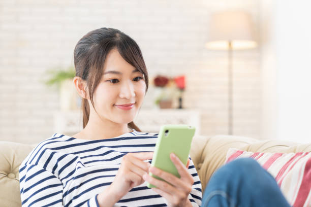 istock attractive Asian woman using a smart phone 1414870262