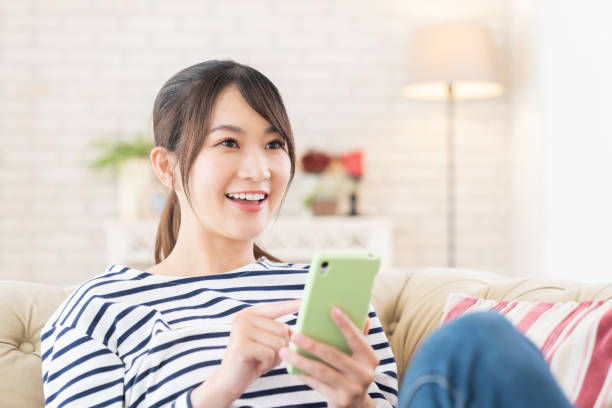 istock attractive Asian woman using a smart phone 1414870275