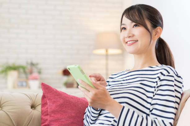 istock attractive Asian woman using a smart phone 1414870421