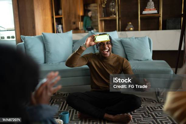 Friends Playing Guessing Game At Home Stock Photo - Download Image Now - Charades, Playing, Playful