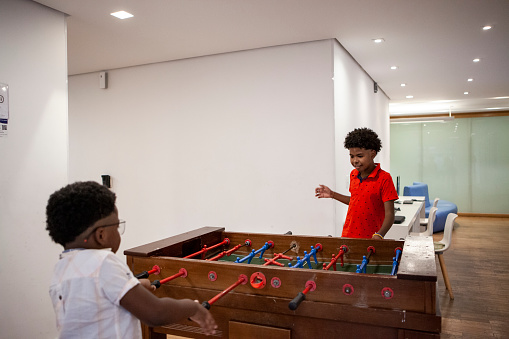 Brothers playing foosball