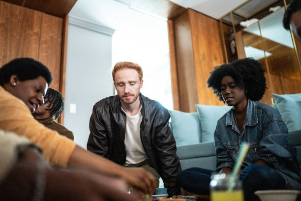 istock Friends playing board game at home 1414873841