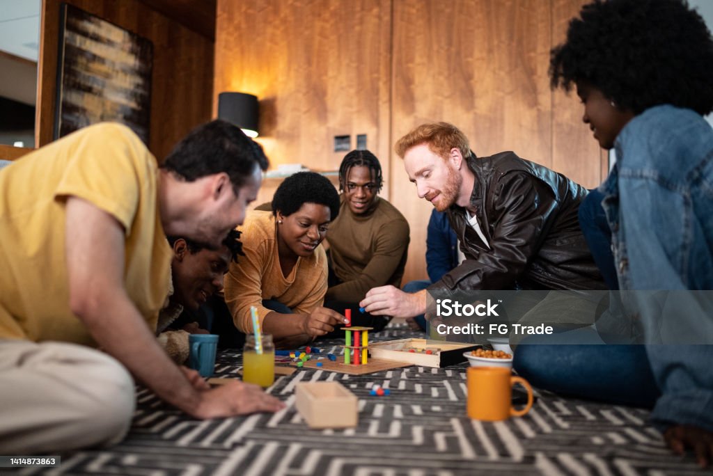 Friends playing board game at home Board Game Stock Photo