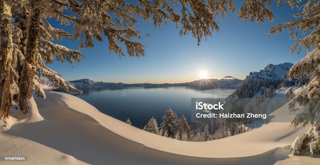 Carter Lake covered in Snow The panoramic view of Crater Lake in partial fog after snow storm Oregon - US State Stock Photo