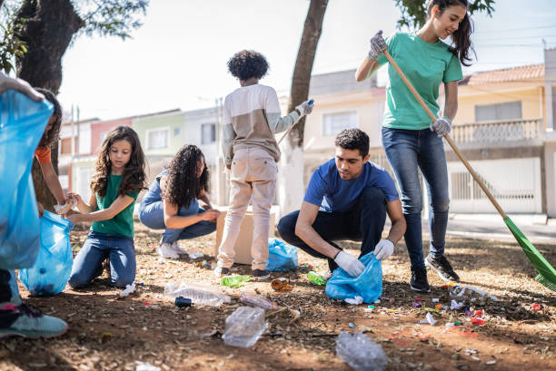 Large group of happy kids cleaning the environment and recycling garbage in springtime.