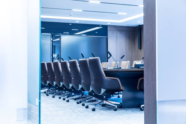 istock Empty modern meeting room with luxurious armchairs and big electronic screen 1414876236