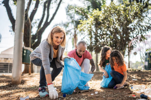 istock People picking up garbage to clean a public park 1414876252