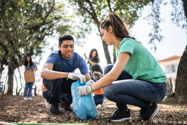 istock Couple picking up garbage to clean a public park 1414876274