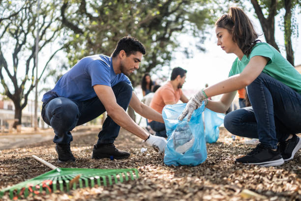 istock Couple picking up garbage to clean a public park 1414876283