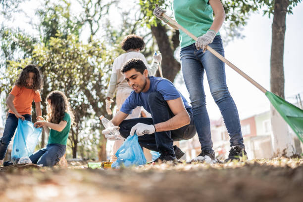 istock People picking up garbage to clean a public park 1414876329