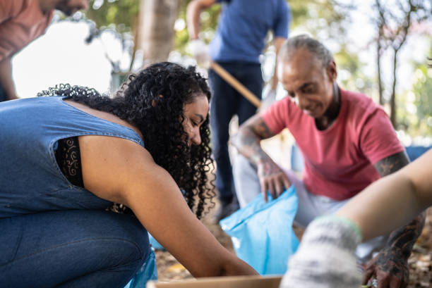 istock People picking up garbage to clean a public park 1414876349