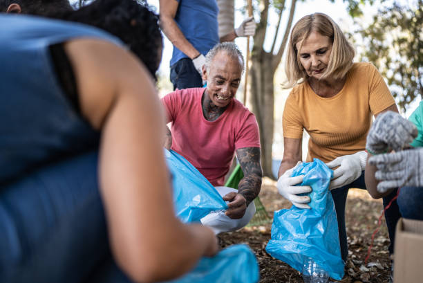 istock People picking up garbage to clean a public park 1414876351
