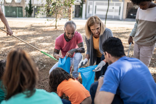 istock People picking up garbage to clean a public park 1414876479