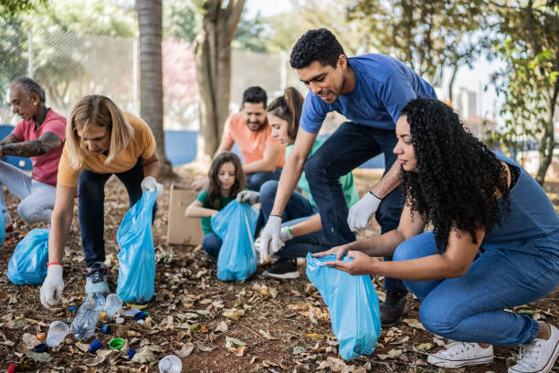 istock People picking up garbage to clean a public park 1414876500