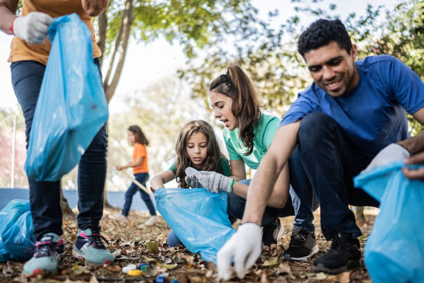 istock People picking up garbage to clean a public park 1414876525