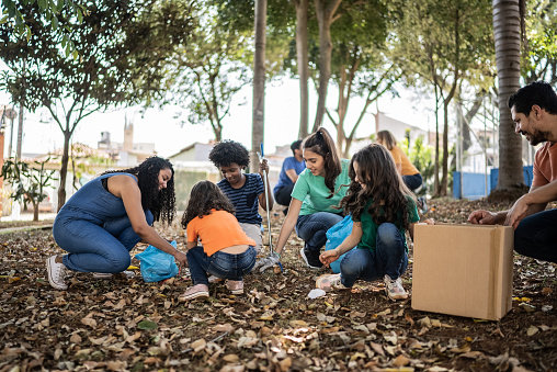 People picking up garbage to clean a public park