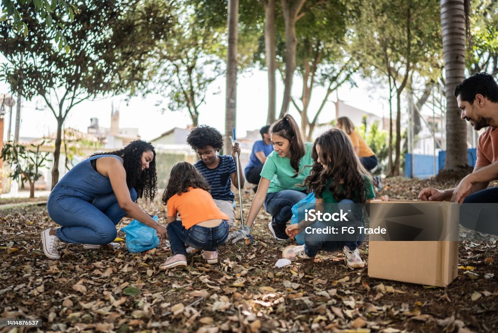 People picking up garbage to clean a public park Cleaning Stock Photo