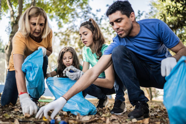 istock People picking up garbage to clean a public park 1414876539