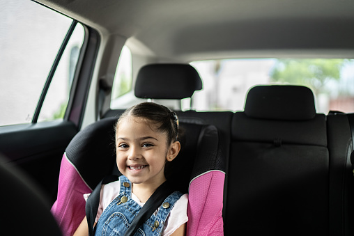 Portrait of cute girl smiling in the car