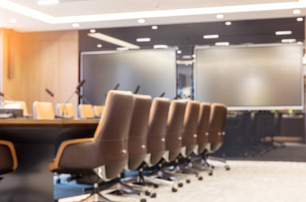 istock Empty modern meeting room with luxurious armchairs and big electronic screen 1414877542