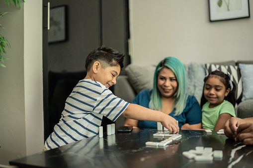 Family playing domino and having fun at home