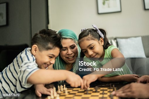 istock Family playing chess at home 1414877670
