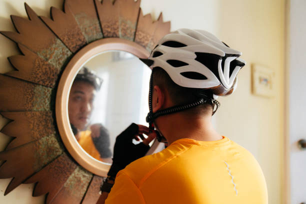 istock man putting on helmet  at home 1414878705