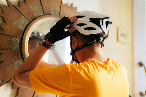 man putting on helmet  at home