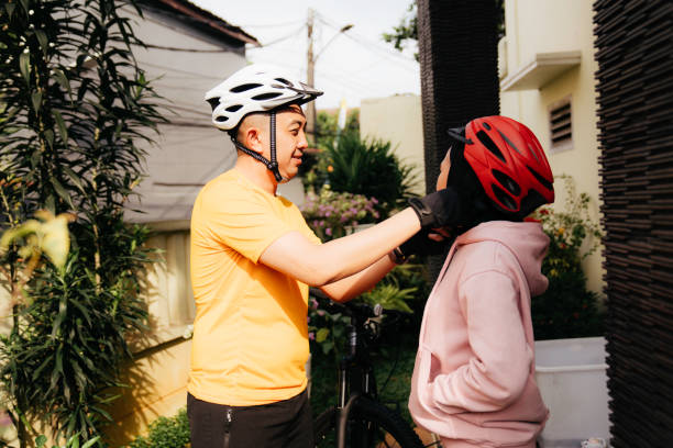 istock Young man assist her girlfriend using bike helmet 1414878715