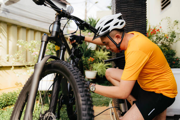 istock man  fixing bicycle on sunny day 1414878717