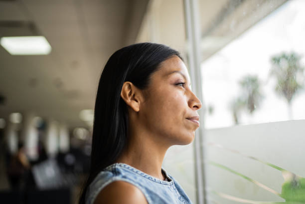 istock Young woman looking away contemplating 1414879898