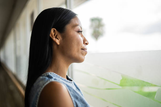 istock Young woman looking away contemplating 1414879907