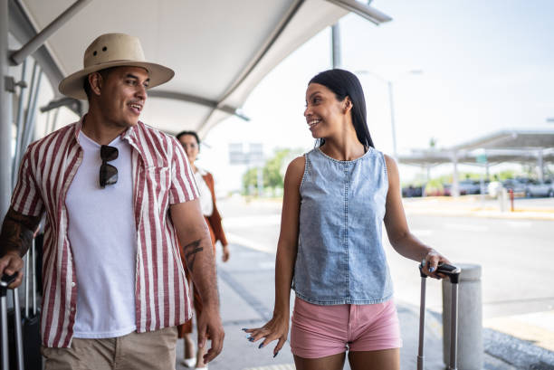 istock Couple leaving the airport after a flight 1414881066
