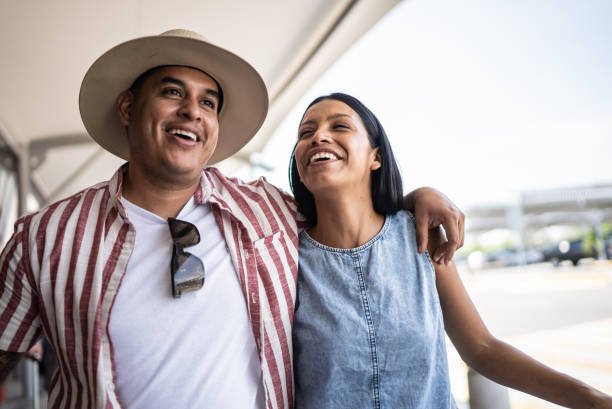 istock Couple leaving the airport after a flight 1414881072