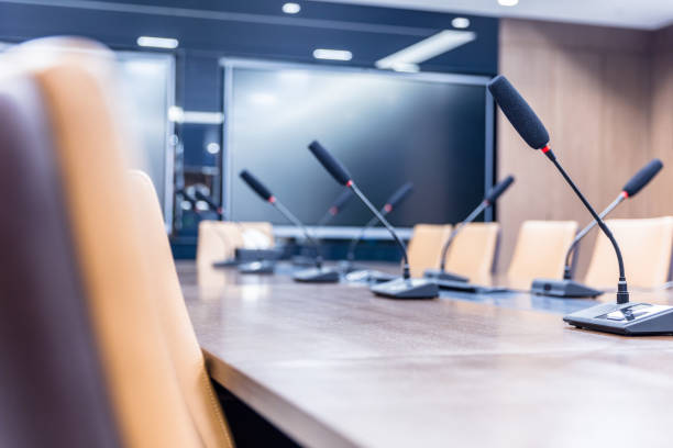 istock Modern conference room with monitors and microphones 1414883097