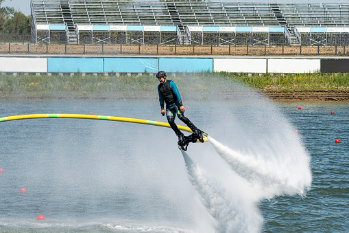 June 10, 2022. Barnaul Russia: A man performs dangerous stunts on the water. flying with a flyboard.