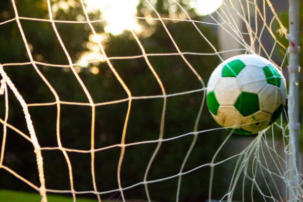 istock Soccer ball in the goal 1414889447