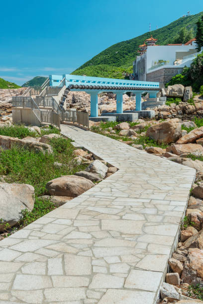 Wooden Walkway, Rocky coast and White sand beach with blue sea on KohKham. Sattahip, Chonburi, Thailand
