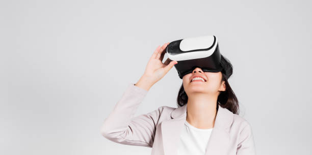 istock Smiling woman confidence excited wear VR headset device during virtual reality experience 1414896757
