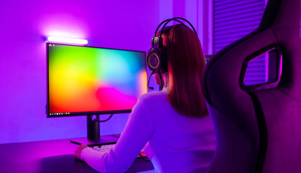 istock Asian professional gamer playing online video game on desktop computer PC have colorful neon LED lights 1414896770