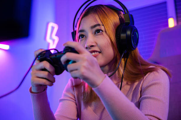 istock Gamer using joystick controller plays online video game with computer neon lights she winning 1414896775