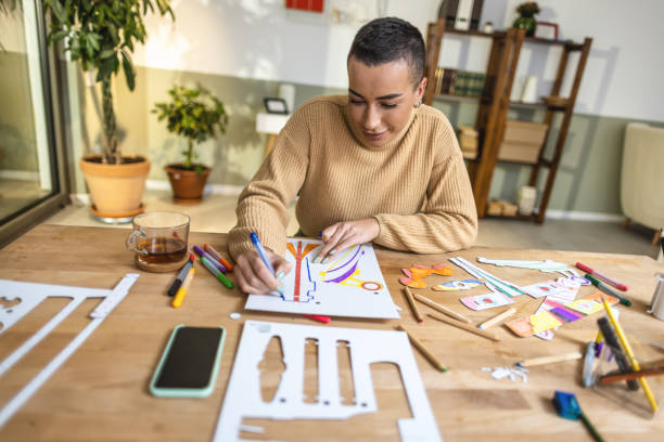 istock Creative young woman drawing at home 1414899021