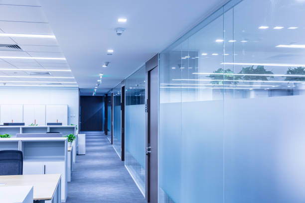 istock Corridor in modern style office. Empty tables, chairs and lockers 1414899066