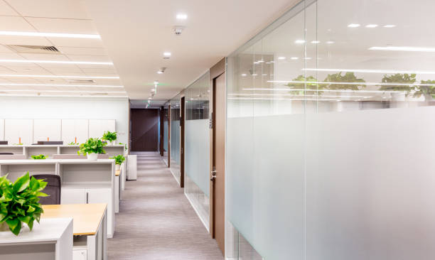 istock Empty modern office interior with tables and armchairs, some plants 1414899675