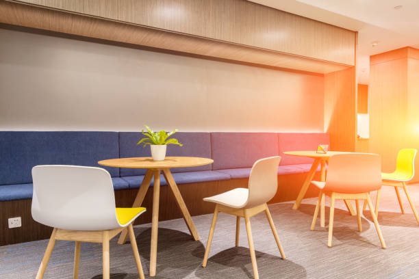istock Cozy lounge area with some round tables and chairs, morning light tone 1414899766