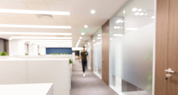 istock Corridor in a modern office with blurred silhouettes，Defocusing effect 1414903535