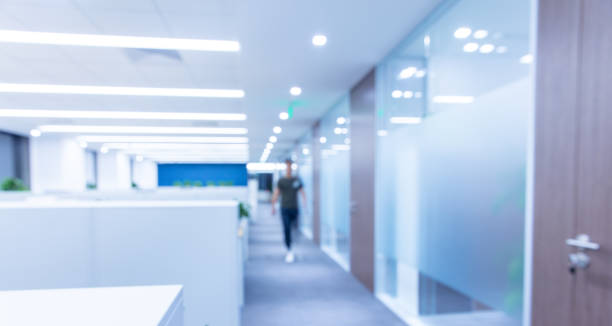 istock Corridor in a modern office with blurred silhouettes，blurry bokeh 1414903577