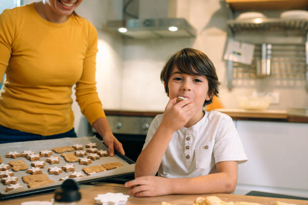 istock mother and son making cookies at home kitchen 1414903943