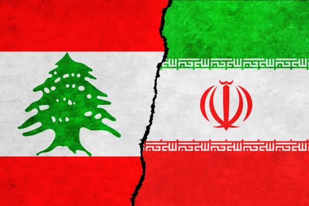 istock Lebanon and Iran painted flags on a wall with a crack 1414909126